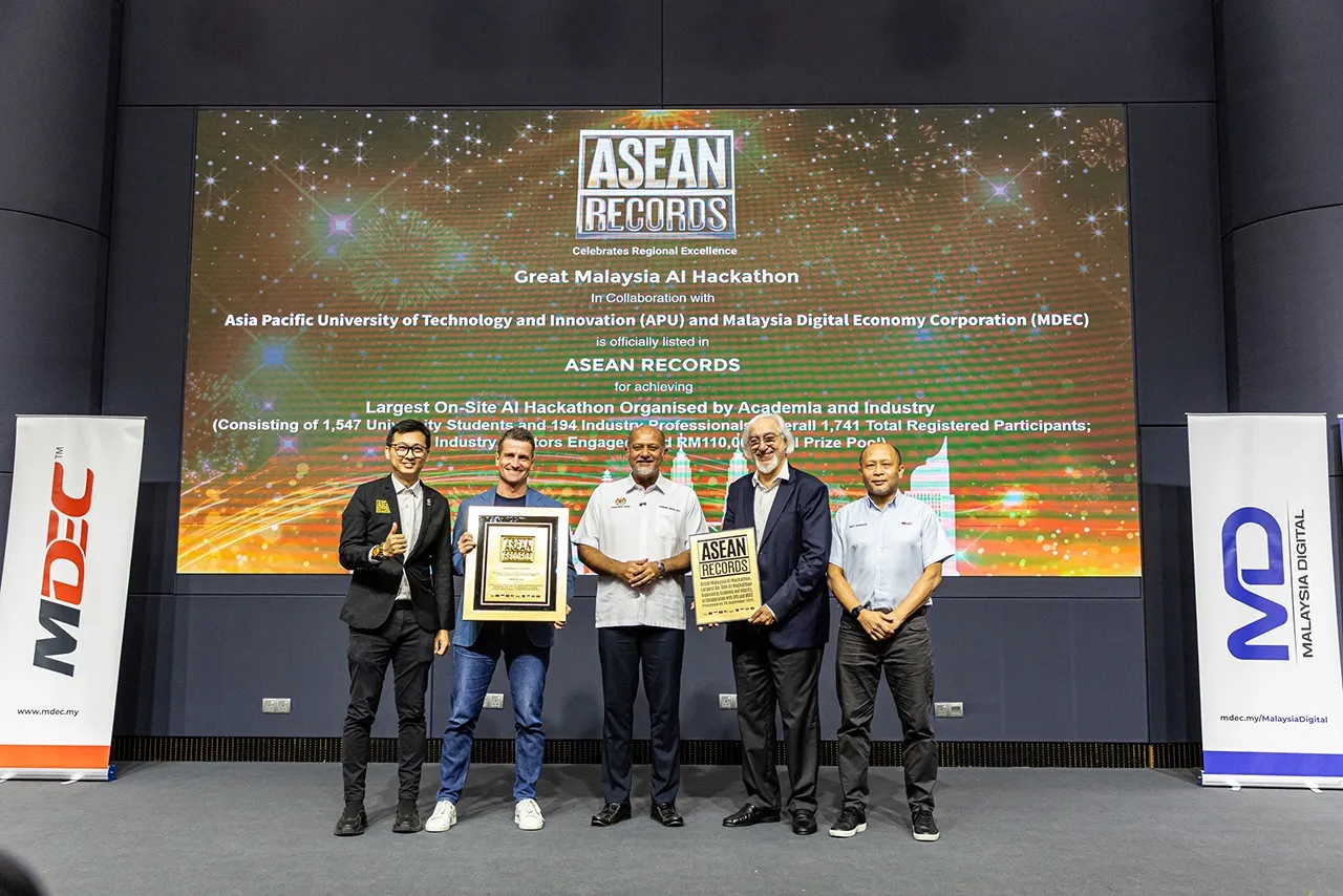 Five people on stage holding the ASEAN Records certificate for the Great Malaysia AI Hackathon