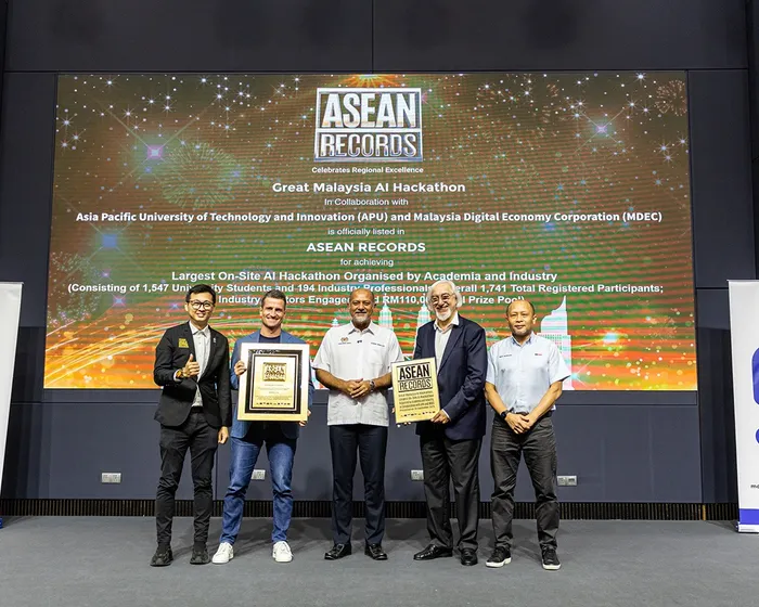 Five people on stage holding the ASEAN Records certificate for the Great Malaysia AI Hackathon